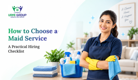 Smiling maid in yellow gloves with cleaning supplies and folded towels, promoting "How to Choose a Maid Service" by URMI Group.